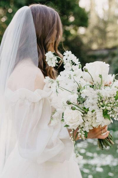 Bride from behind, holding a bouquet